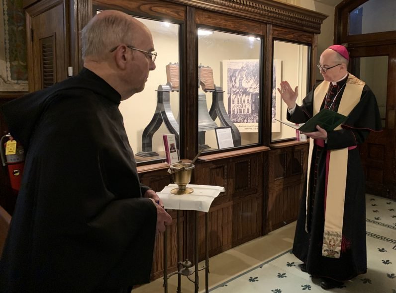   Philadelphia Auxiliary Bishop Timothy Senior blesses the Sister Bell May 7, assisted by Augustinian Father Bill Waters, pastor of St. Augustine Parish in Philadelphia, the bell’s historic and now permanent home. (Gina Christian)  