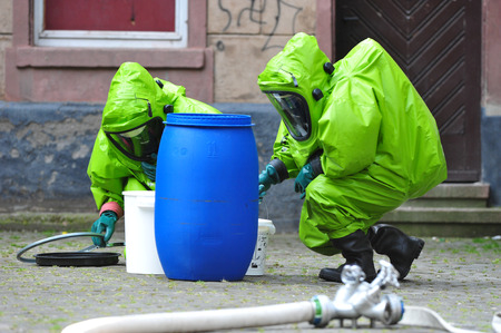 Chemists exploring barrel after spill at school Image Copyright : Rainer Klotz