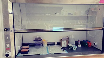Before: Cluttered fume hood