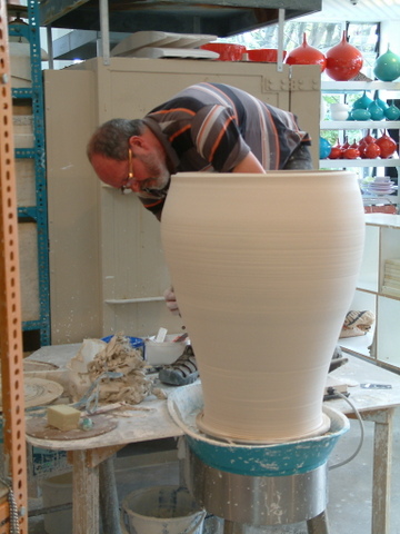 Peter learnt to ‘throw’ pots on the pottery wheel as a teenager in the 60’s. The basic premise is to centre a lump of clay on a turning wheel, open it up and use the hands to pull the clay into the desired form. Every potter develops his or her own unique methods and Peter is renowned for his accurate throwing of fine forms from delicate and tiny to sculptural and large. The leather hard pot is often returned to the wheel and re-centered for the final refining with tools, cutting away excess clay, adding details, foot rings etc… Only then can handles or spouts be added to the round forms.