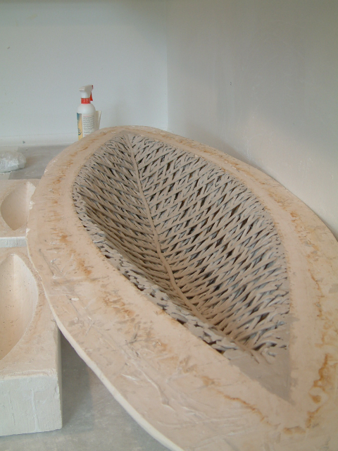 Weaving the paper clay in the plaster form