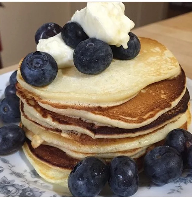 A simple stack of pancakes with a surprise: Lemon ricotta pancakes with a dollop of lemon cream cheese and Jersey fresh blueberries.