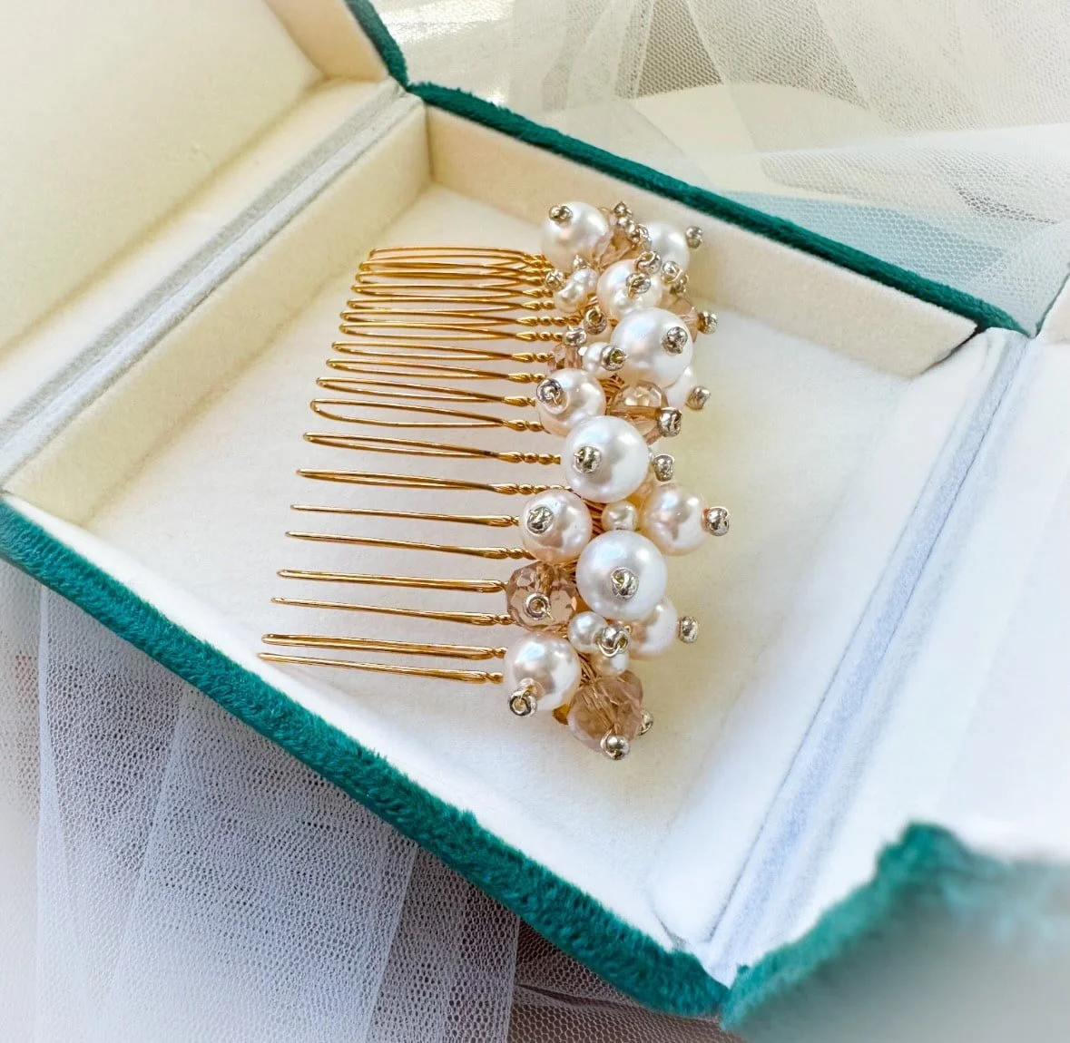 pearl hair comb in blue velvet box.