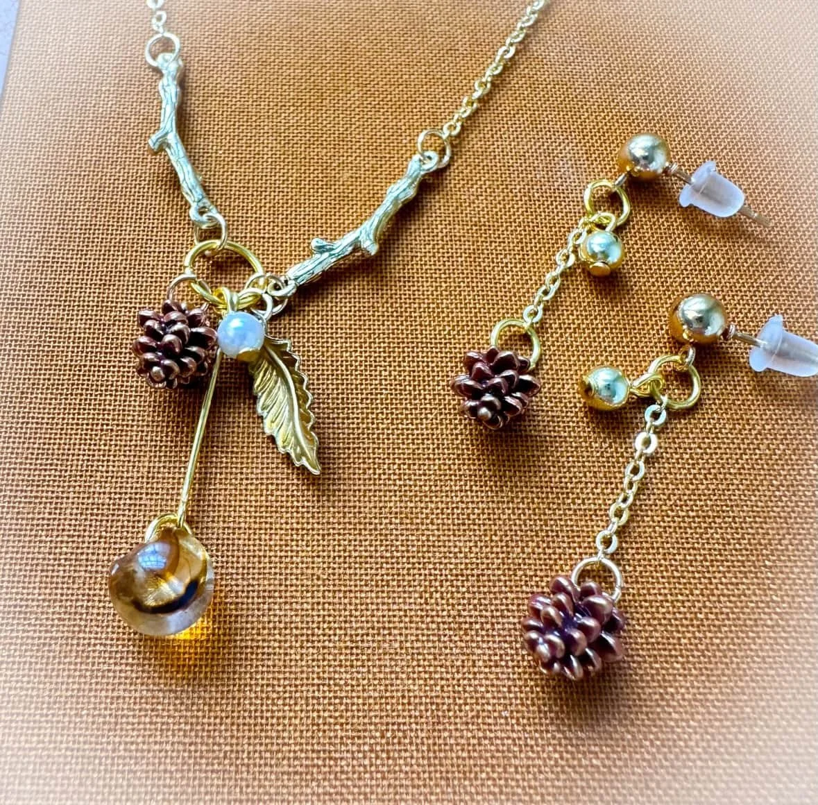 Necklace and earrings set with tiny pine cone charms and amber bead