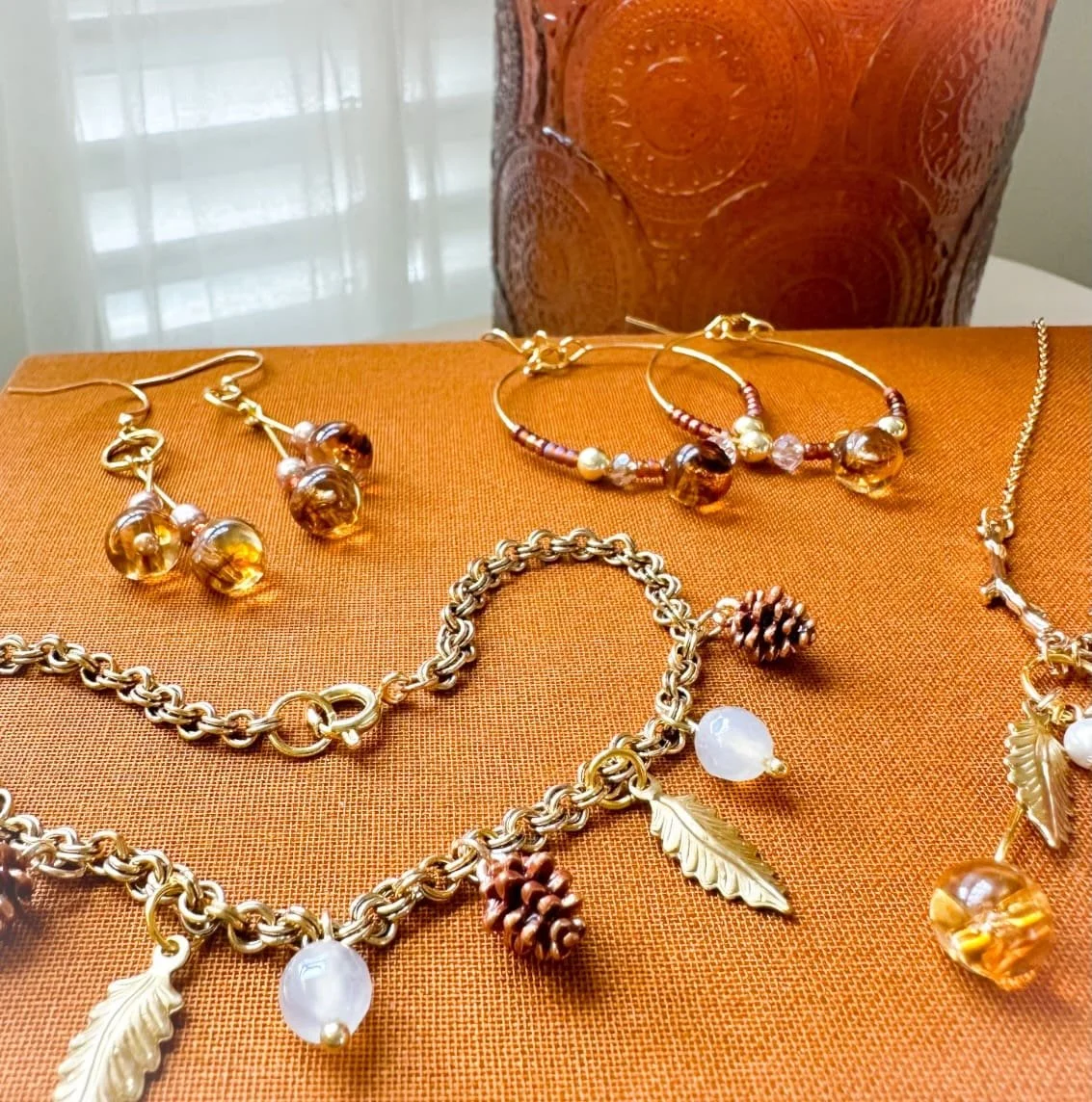 brown pine cone fall charm bracelet with pumpkin spice candle