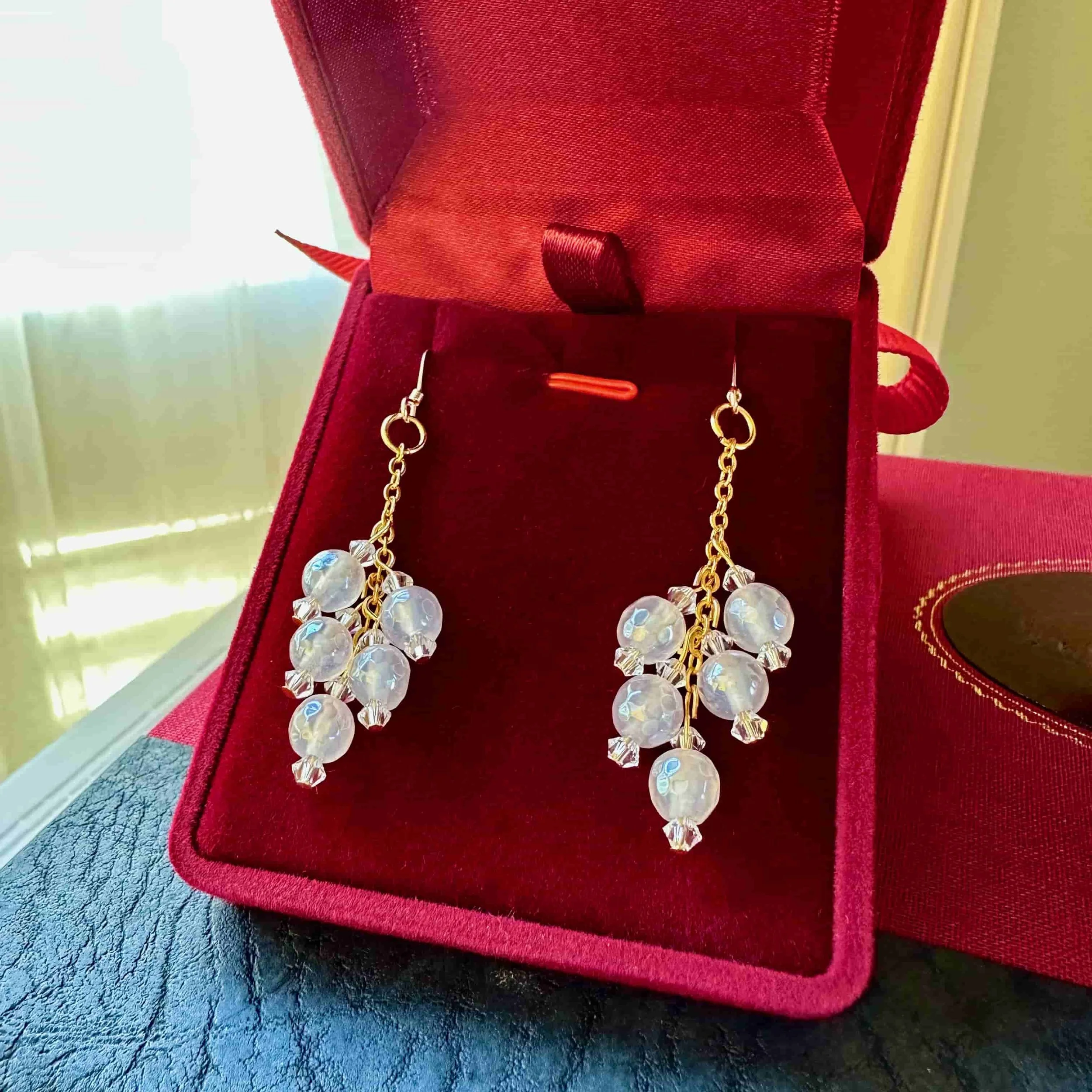 mystic agate dangle earrings in red velvet case