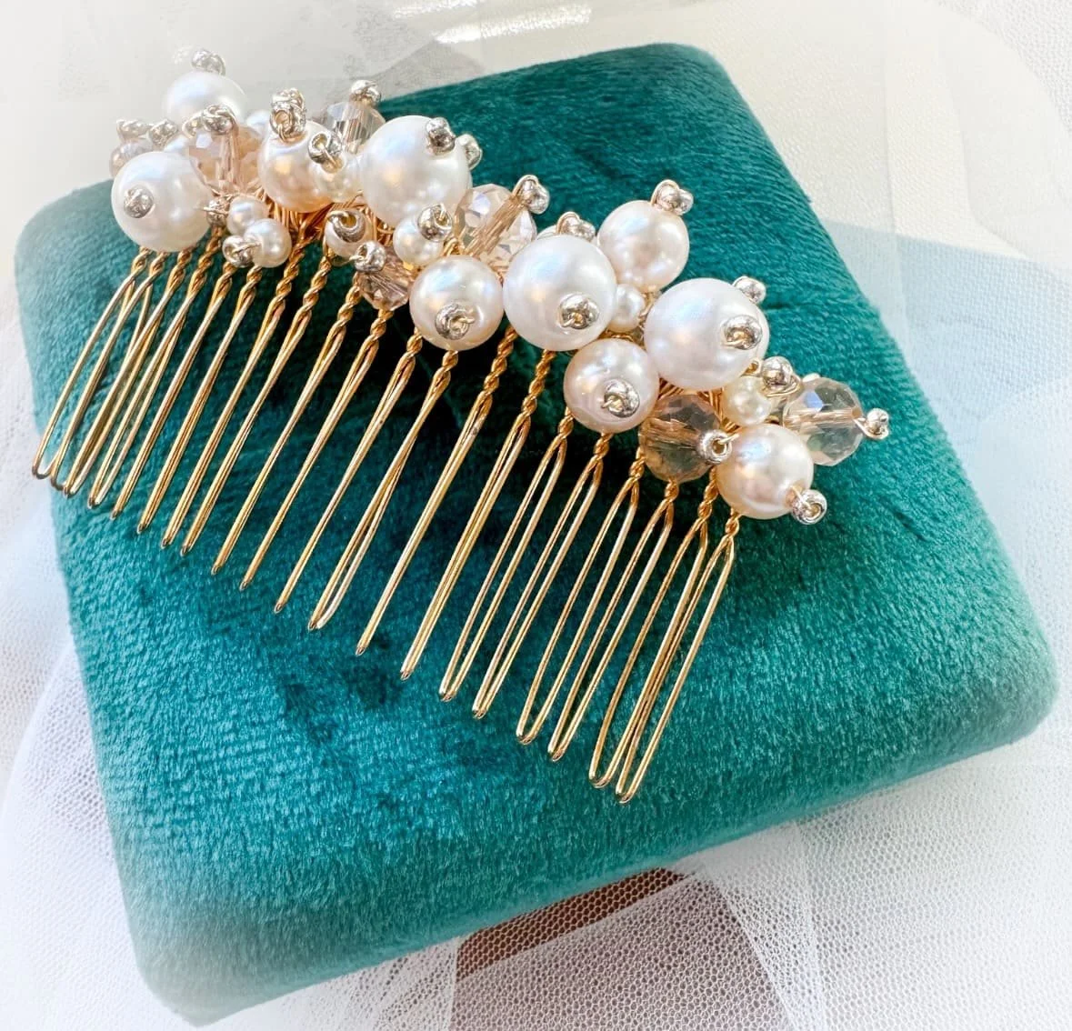pearl hair comb in blue velvet box.