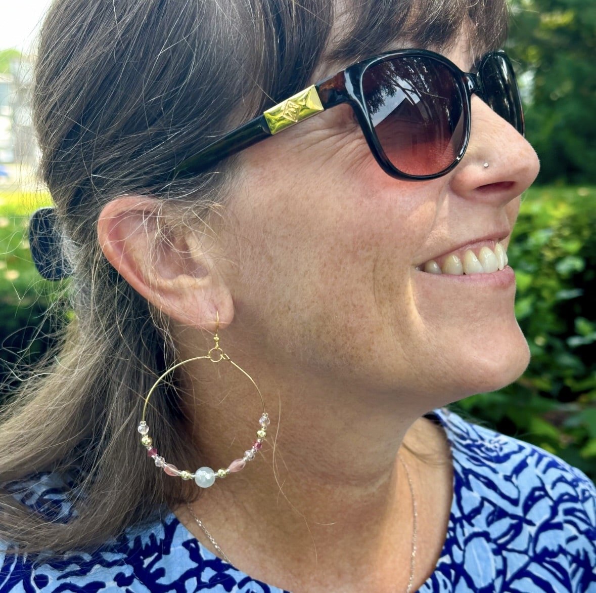 large and small hoop earrings, pink and gold beads, worn in the ear