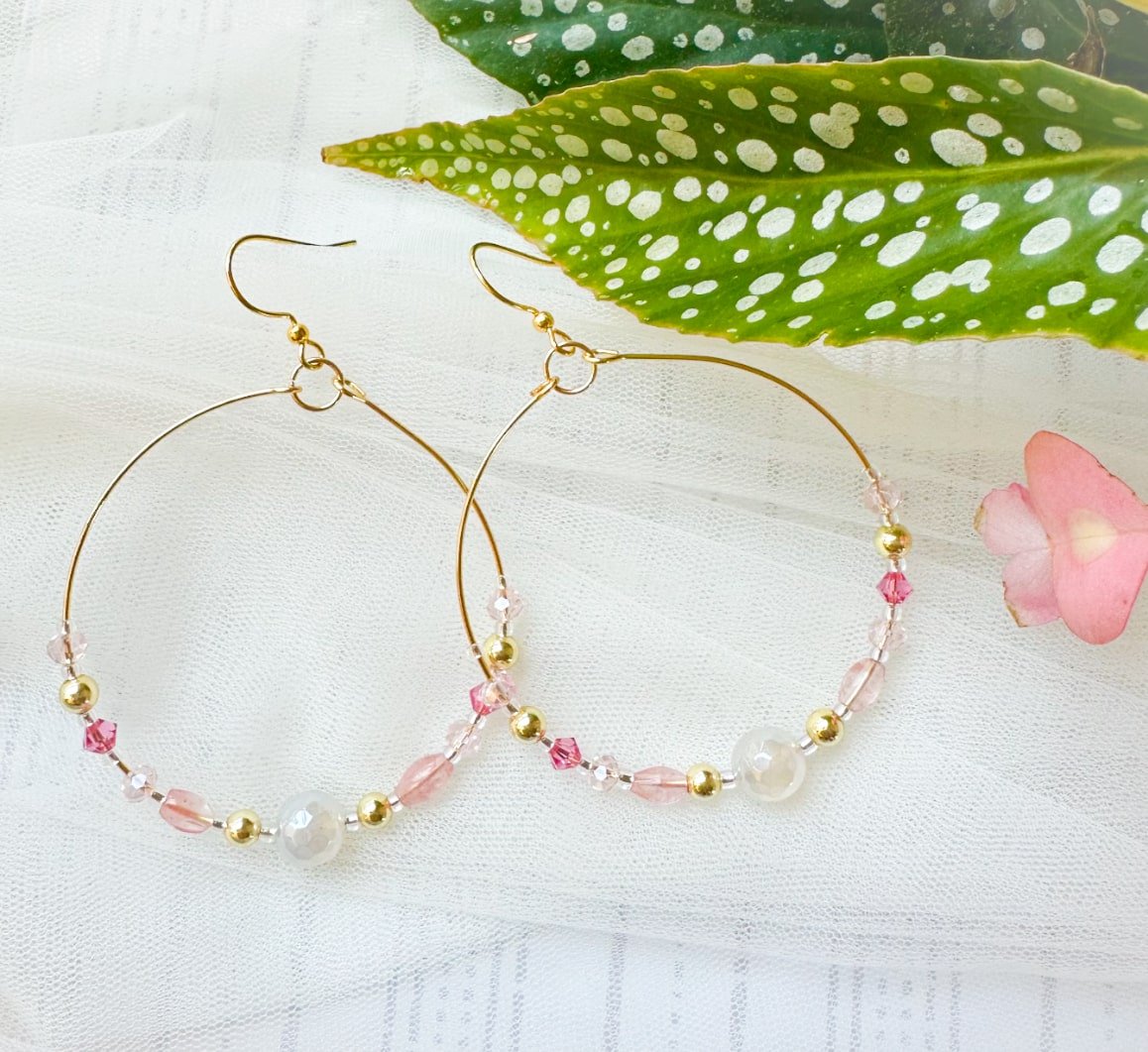 large and small hoop earrings, pink and gold beads,