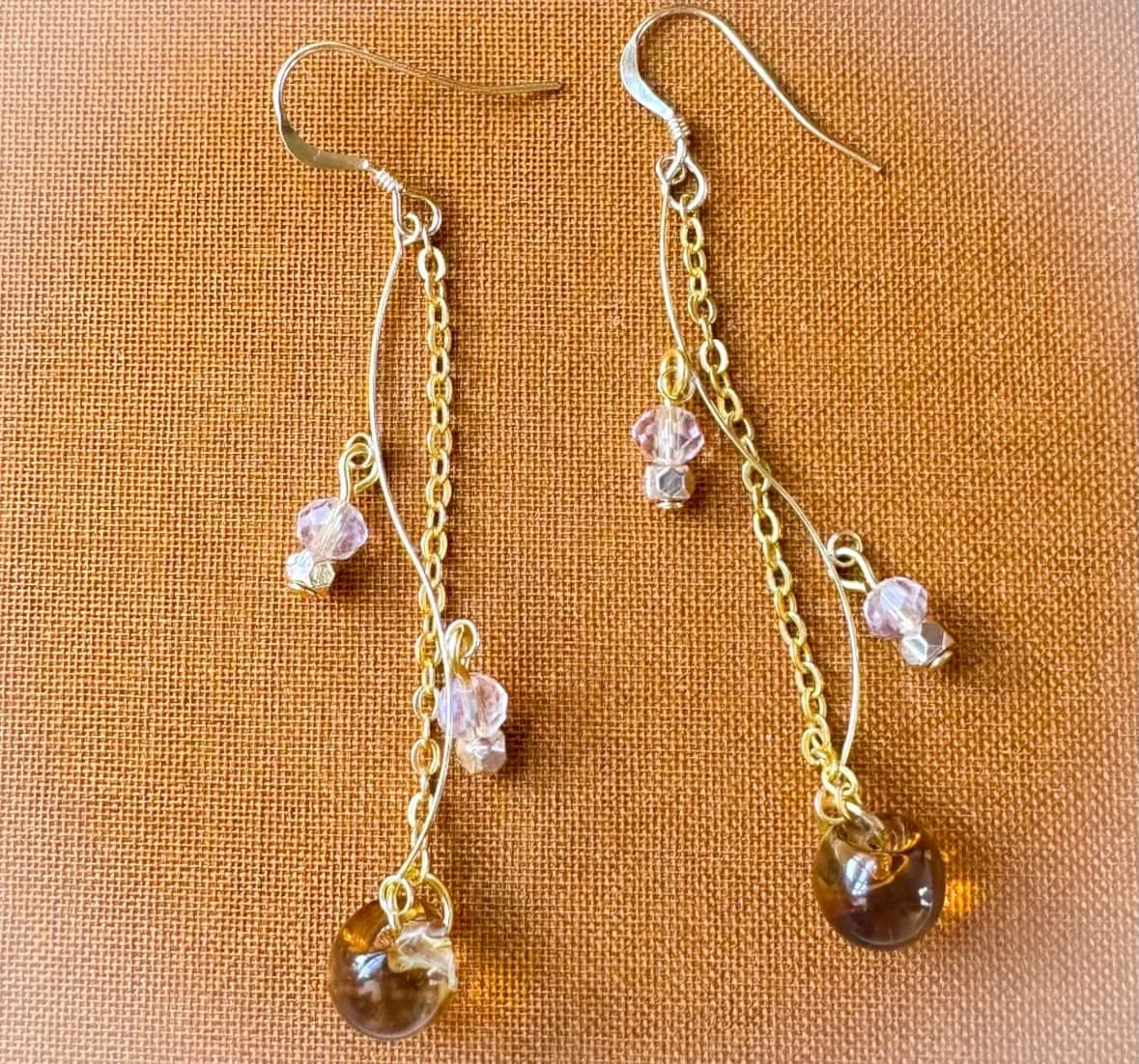 Fall Sunrise earrings on a brown vintage book.