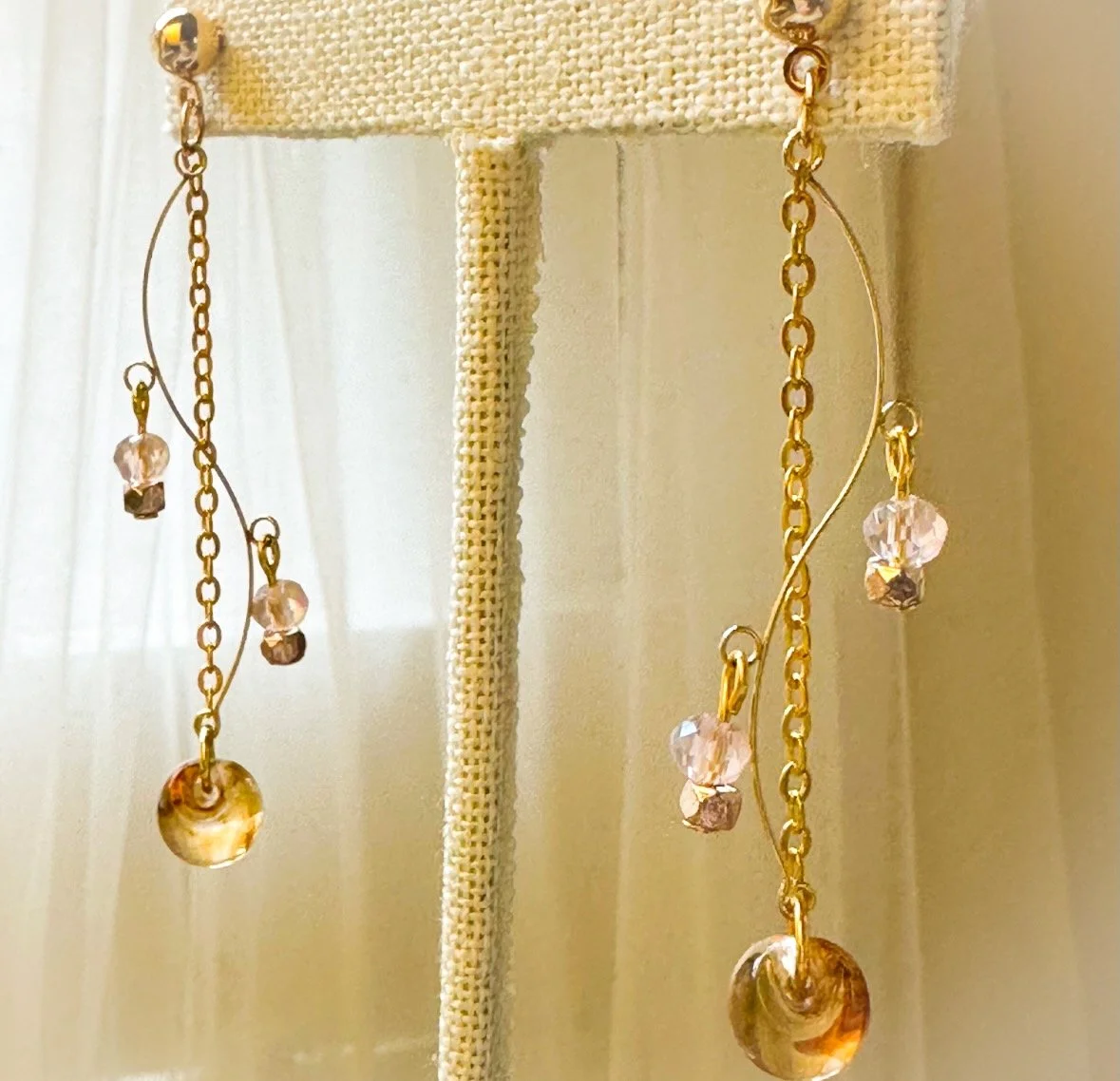 Fall earrings with s-shape amber and crystals.