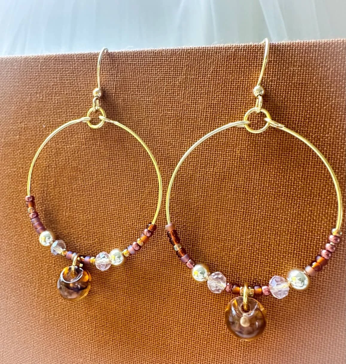 Large hoops with amber bead in Fall colors.