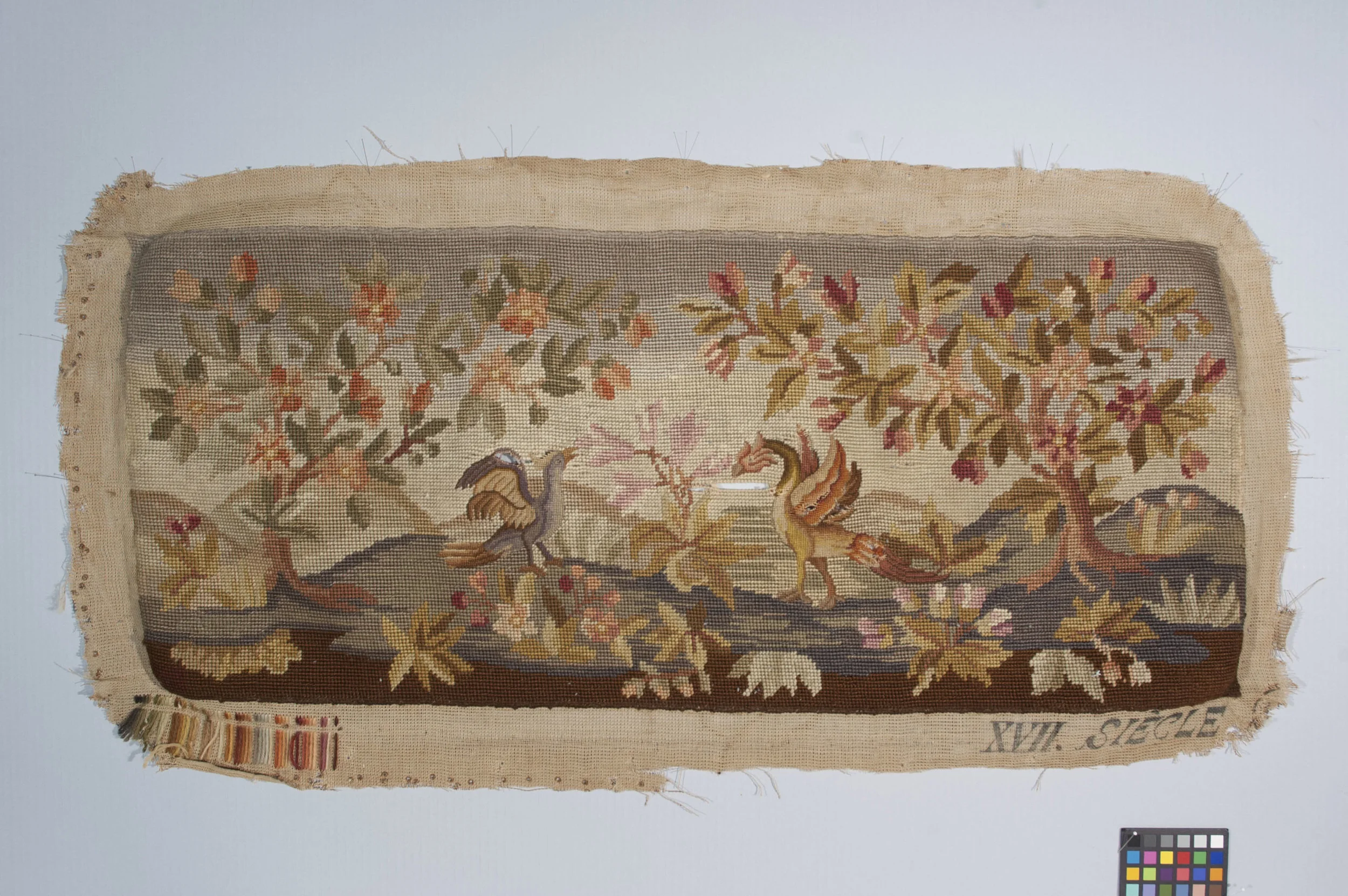 Needlepoint before treatment, after removal from the bench