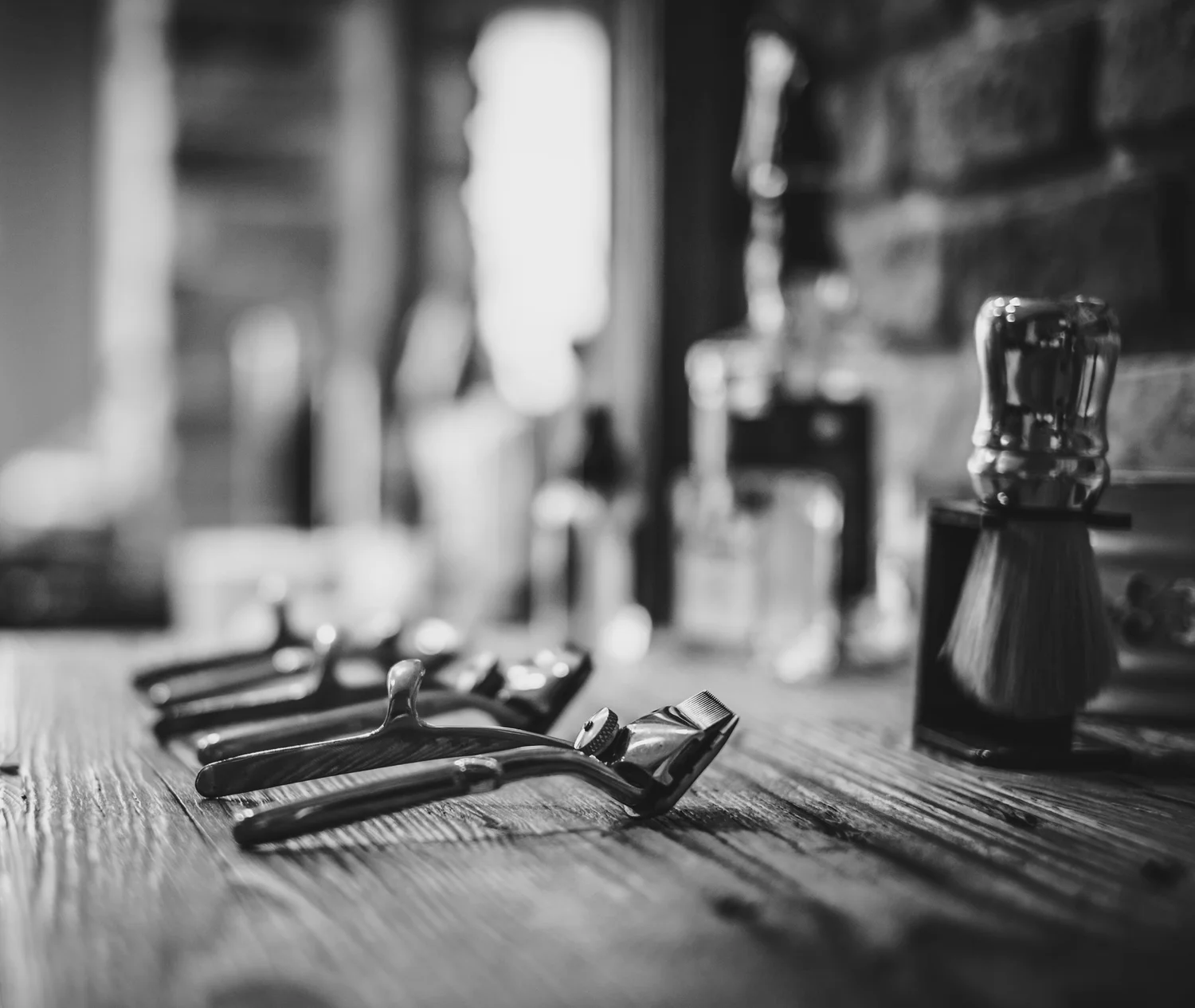 Barber clippers lined up on the counter at Barberstry & Company in Englewood, FL