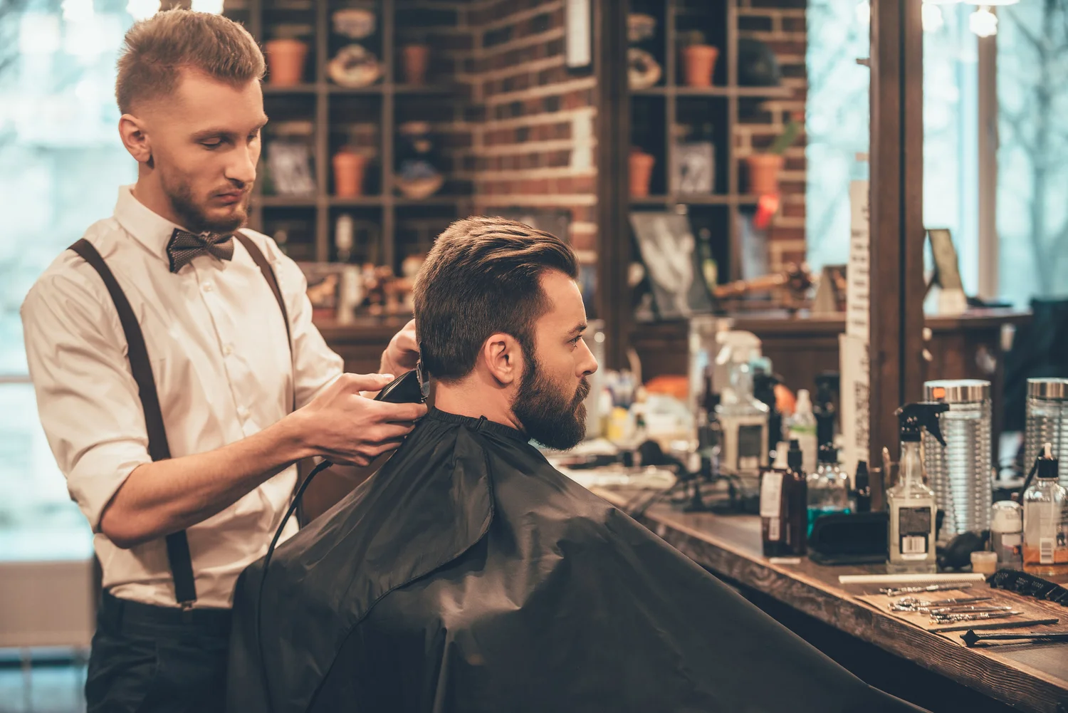 A barber gives a client a precision haircut