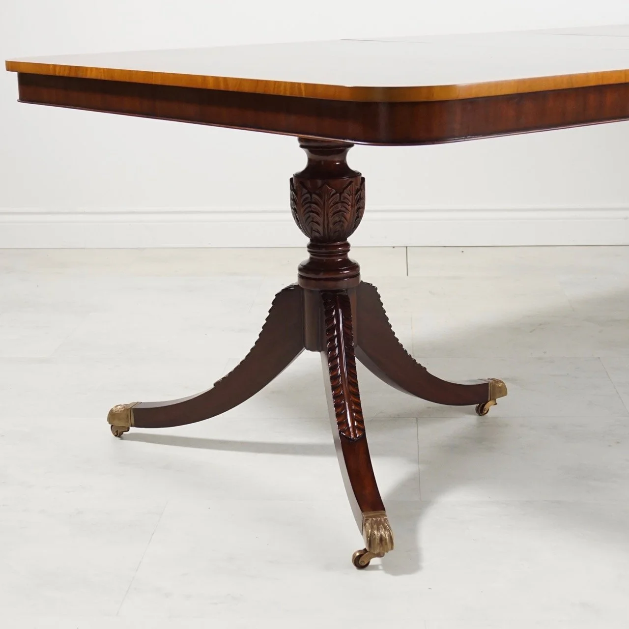 Flamed Mahogany Pedestal Dining Table. Bespoke and Custom fine furniture store Morristown and New York City. Furniture showroom, custom tables, custom sofas, upholstery, and window treatments.