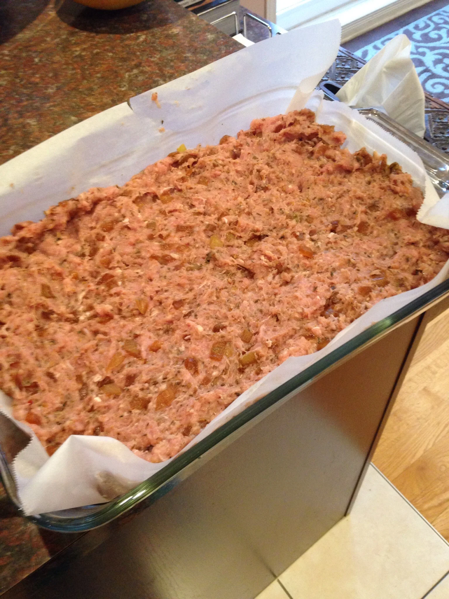 Spreading the turkey mixture in the Pyrex dish (lined with parchment paper).