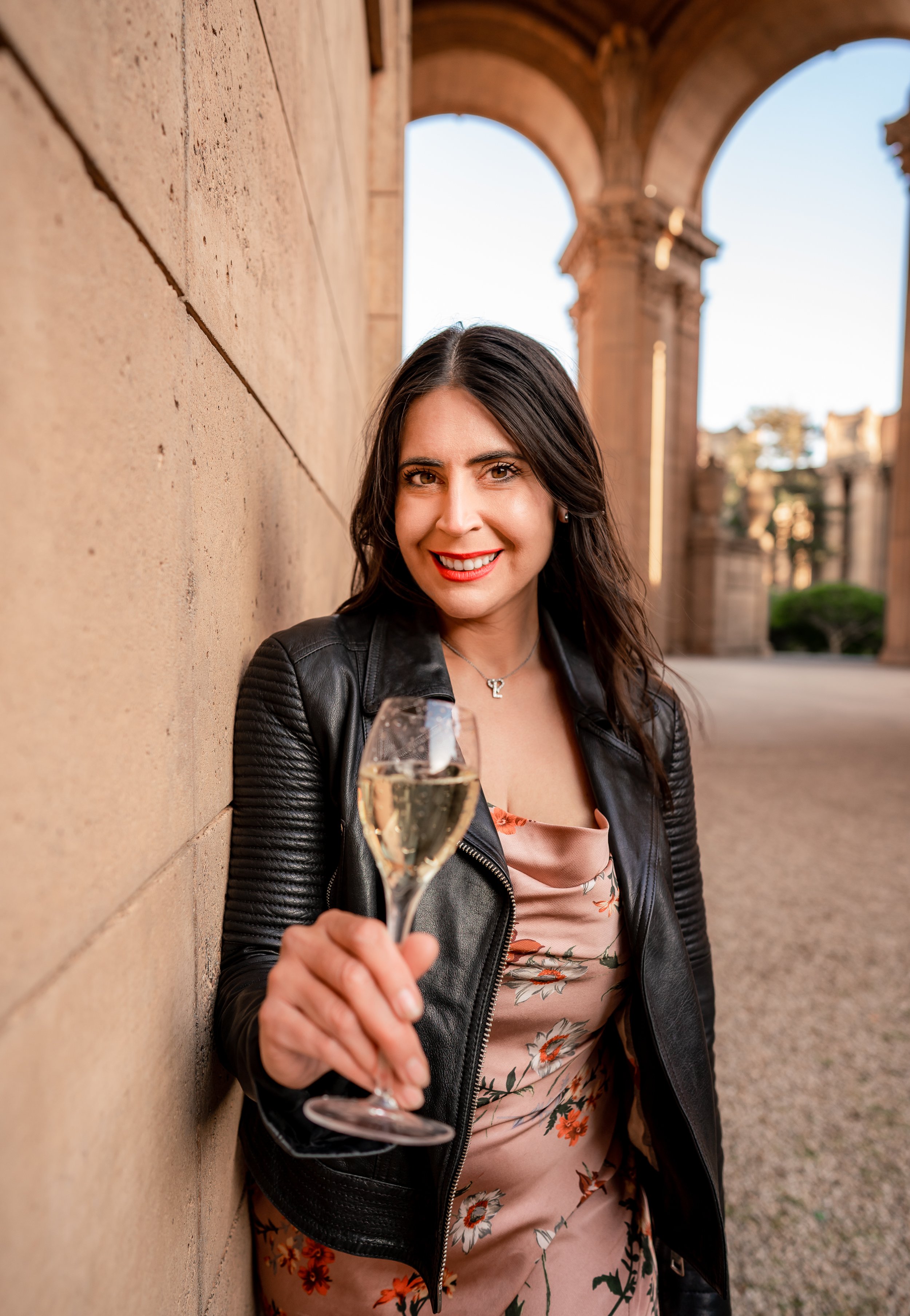 Travel and Champagne Curator Laura Villanueva holding a glass of champagne