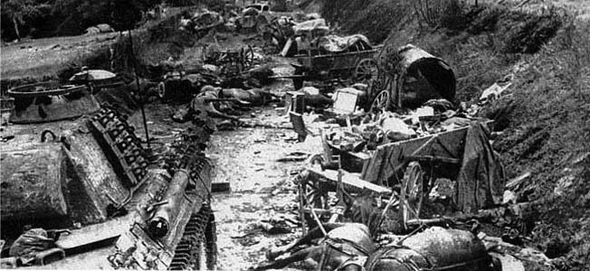 Destroyed and abandoned German armor and motor transport litter a road in the region of Falaise.