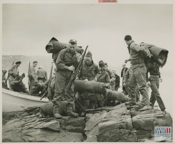 A US shore party prepares to search a section of coastline for German weather stations. Source: The National World War II Museum.
