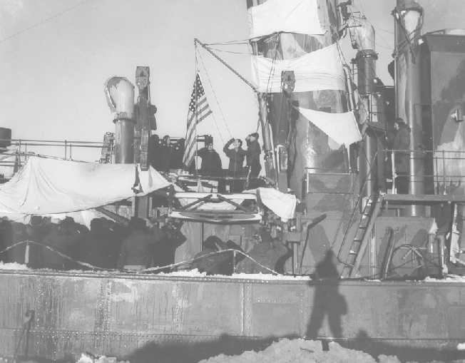 Members of the Coast Guard raise the flag aboard the Externsteine on October 16, 1944. Source: US Coast Guard.