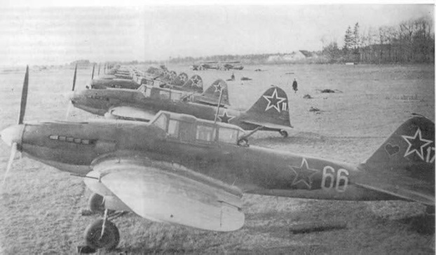 A group of Il-2M3s lined up at an airfield.