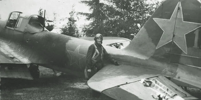 A pilot poses with his damaged Il-2 following a mission.&nbsp;In this instance, flak has damaged the elevator.