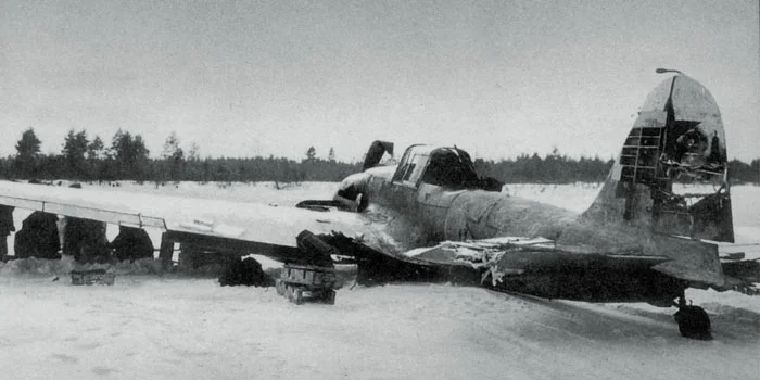 This Il-2M3 has made a wheels-up landing following severe flak damage to the vertical stabilizer. Note the crude whitewash pattern applied over the aircraft's camoflauge. Whitewash was generally applied in the field with whatever materials were on h…
