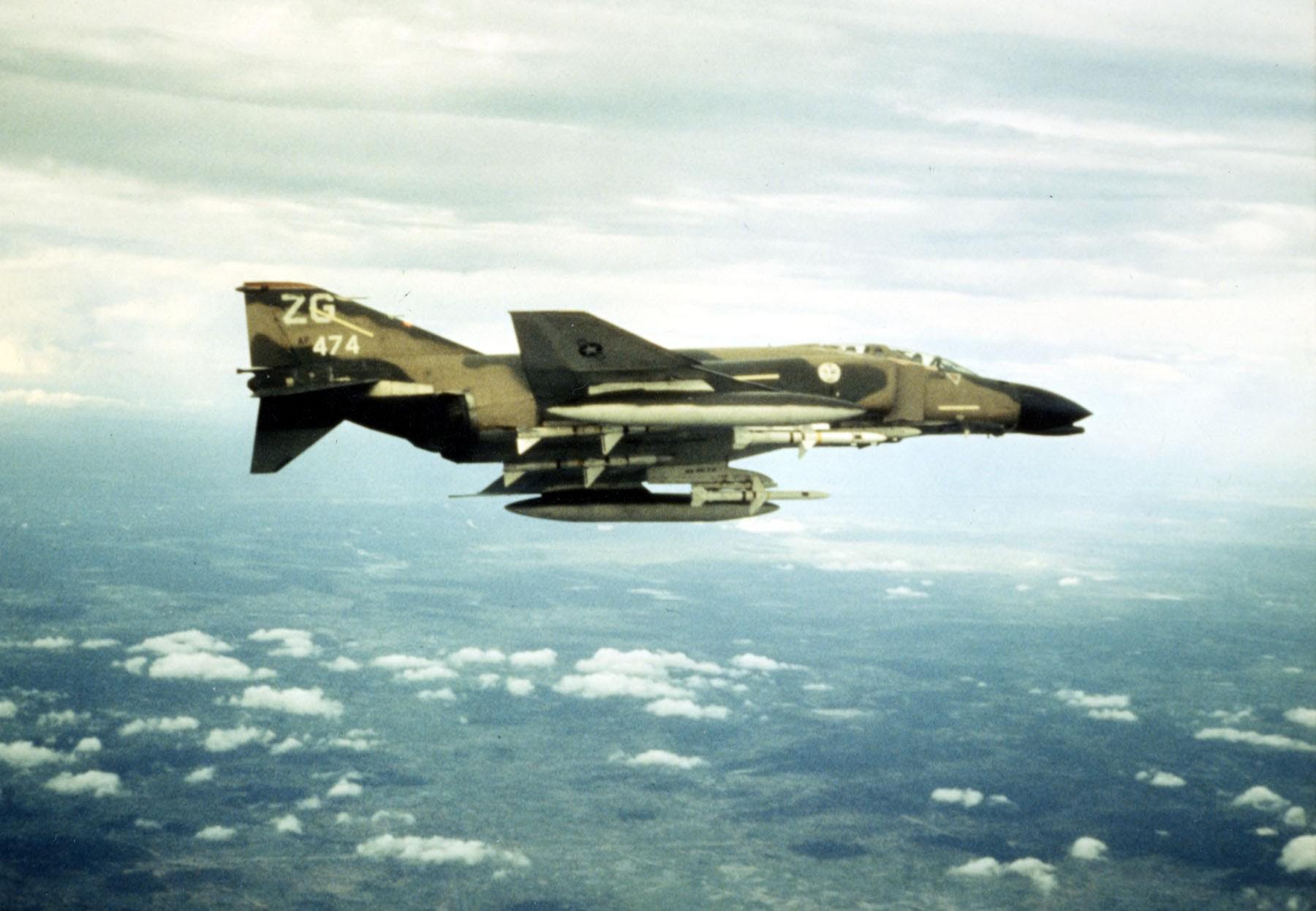 An F-4 Phatom loaded with fuel tanks and four Sparrow missiles patrols the skies above Vietnam.