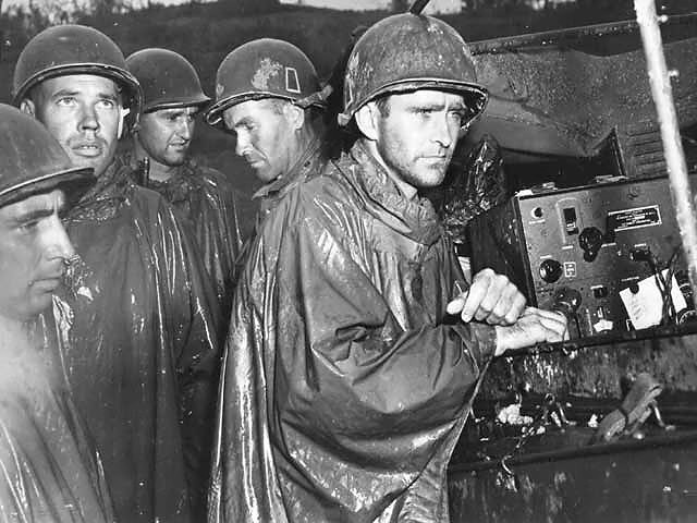 Members of the 77th Infantry Division during a rainstorm on Okinawa.