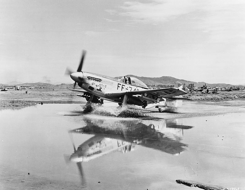 A USAF F-51D (During the interwar period, a redesignation of fighter aircraft from "pursuit" to "fighter" occurred) taxies through a puddle in Korea. This aircraft is armed with 2 500 lbs bombs, 4 2.75 inch rockets, and six .50 caliber machine guns. Source: Wikipedia.