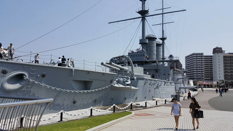 View of the bow of the Mikasa, as it appears today. This view clearly shows the ship's current location on land, with much of its lower decks filled in with concrete. Additionally, the ship's secondary armament, 14 6.5-inch guns, are evident in this…
