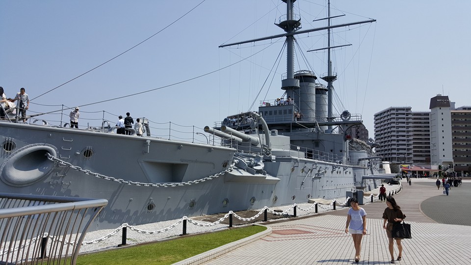VIEW OF THE BOW OF THE MIKASA, AS IT APPEARS TODAY. THIS VIEW CLEARLY SHOWS THE SHIP'S CURRENT LOCATION ON LAND, WITH MUCH OF ITS LOWER DECKS FILLED IN WITH CONCRETE. ADDITIONALLY, THE SHIP'S SECONDARY ARMAMENT, 14 6.5-INCH GUNS, ARE EVIDENT IN THIS PICTURE. PHOTO: AUTHOR.