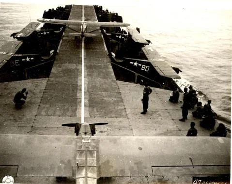 A view from the deck of an LST converted for use as an "aircraft carrier." The aircraft in this picture are Piper L-4 observation aircraft, frequently used for artillery spotting. Photo source: Wikipedia.