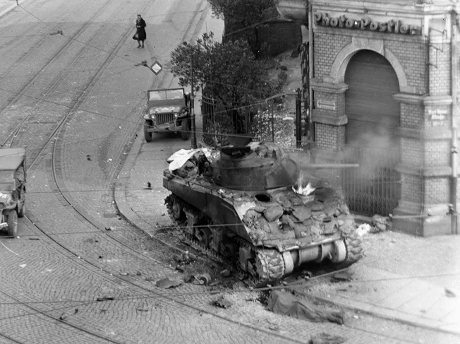 A scene that became all-to-familiar to Allied soldiers in Europe- a Sherman ablaze. Photo source: Wikipedia.&nbsp;
