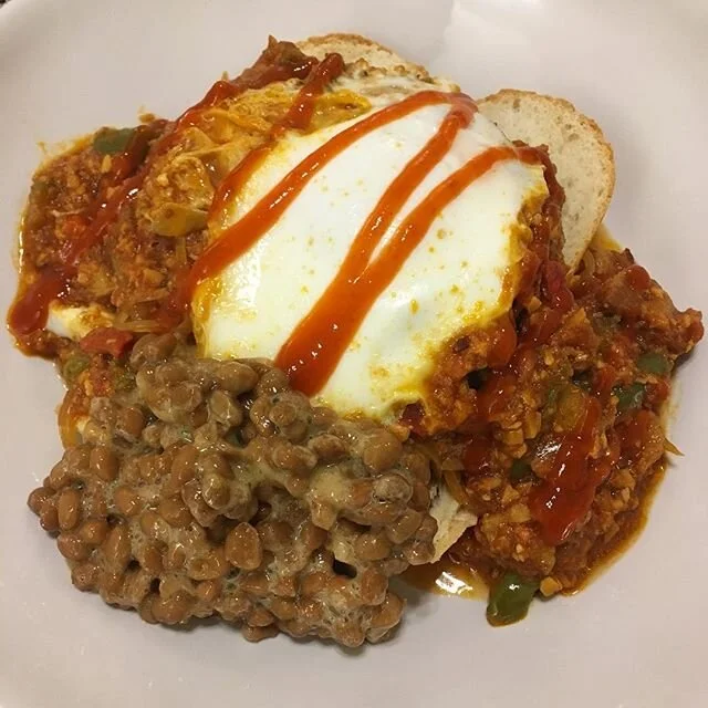 Eggs in Purgatory- tomato sauce with garlic, onion, homegrown chicken in the woods mushroom, cactus, bell pepper and bacon 🤤 turned out pretty well last night with a freshly baked baguette and natto to accompany it! Thanks to @jessmillercreative for