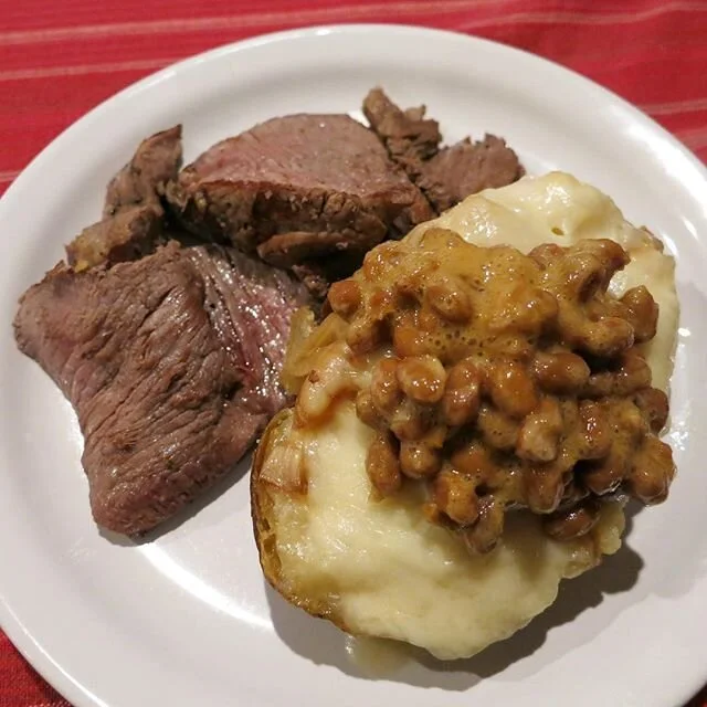 Some leftover dinner we whipped up last night- this is #filetmignon with a #twice #baked #potato with #grilled #onions and #swiss #cheese 😍 I had originally grilled this beautiful filet rare but I cooked it a little more for the second time around ?