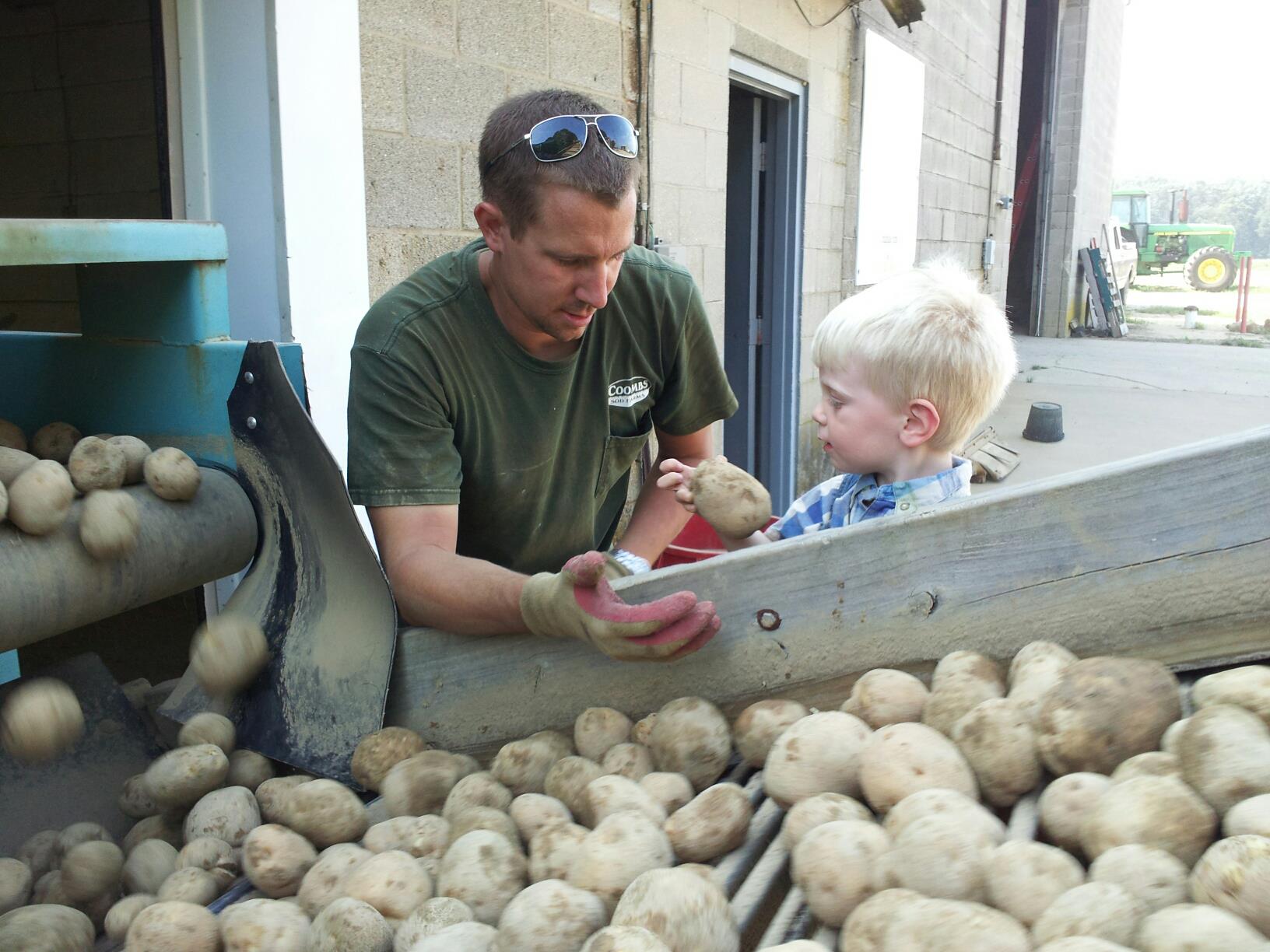 John Jr teaching son Lee about potatoes