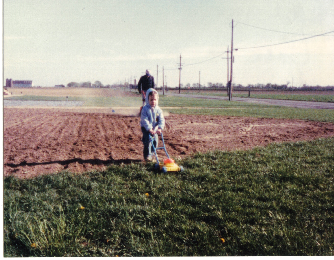  John and John Jr preparing their yard for grass seed in 1986 