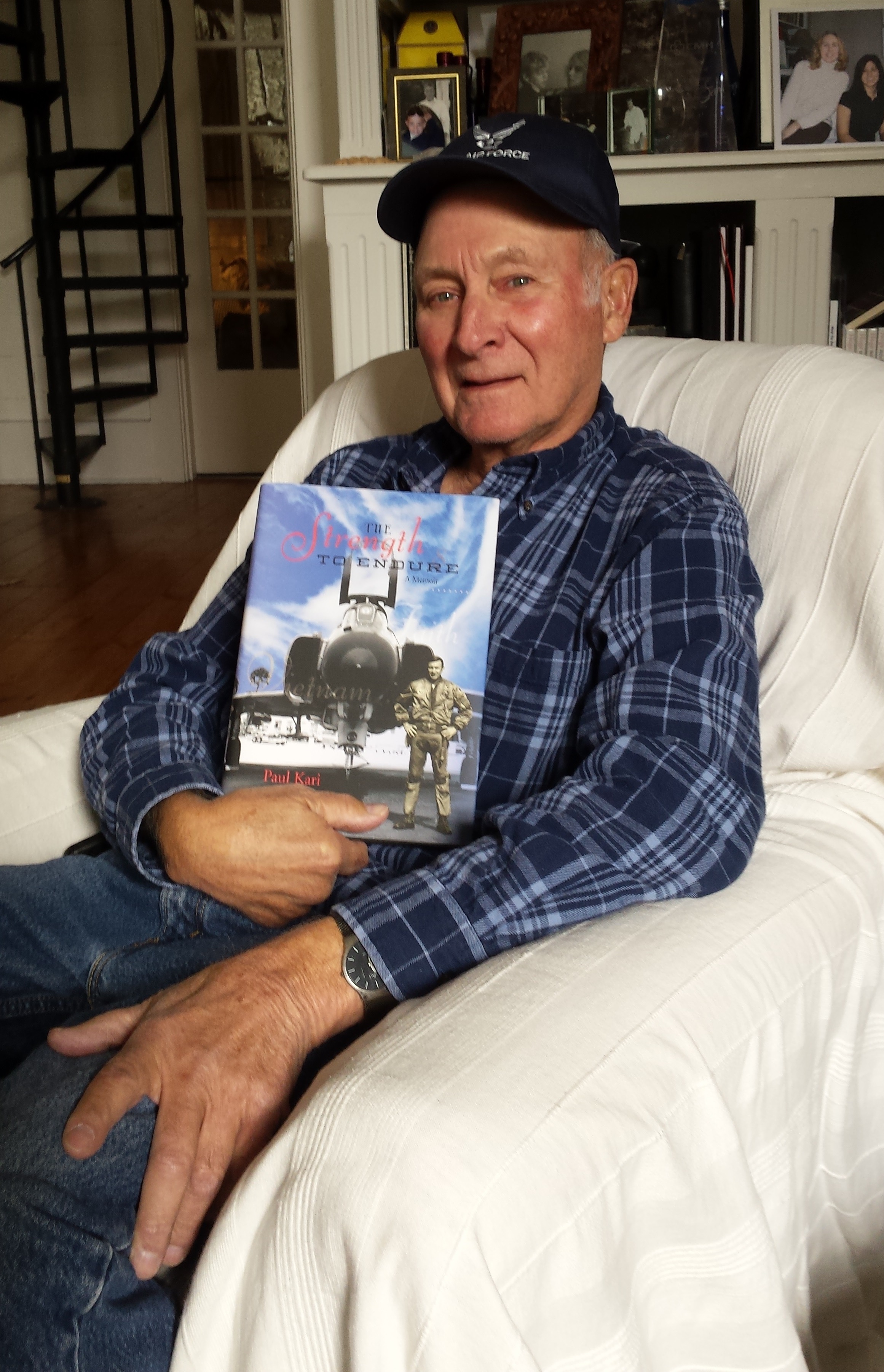 Paul Kari with his memoir, The Strength to Endure, a custom book published by Orange Frazer Press