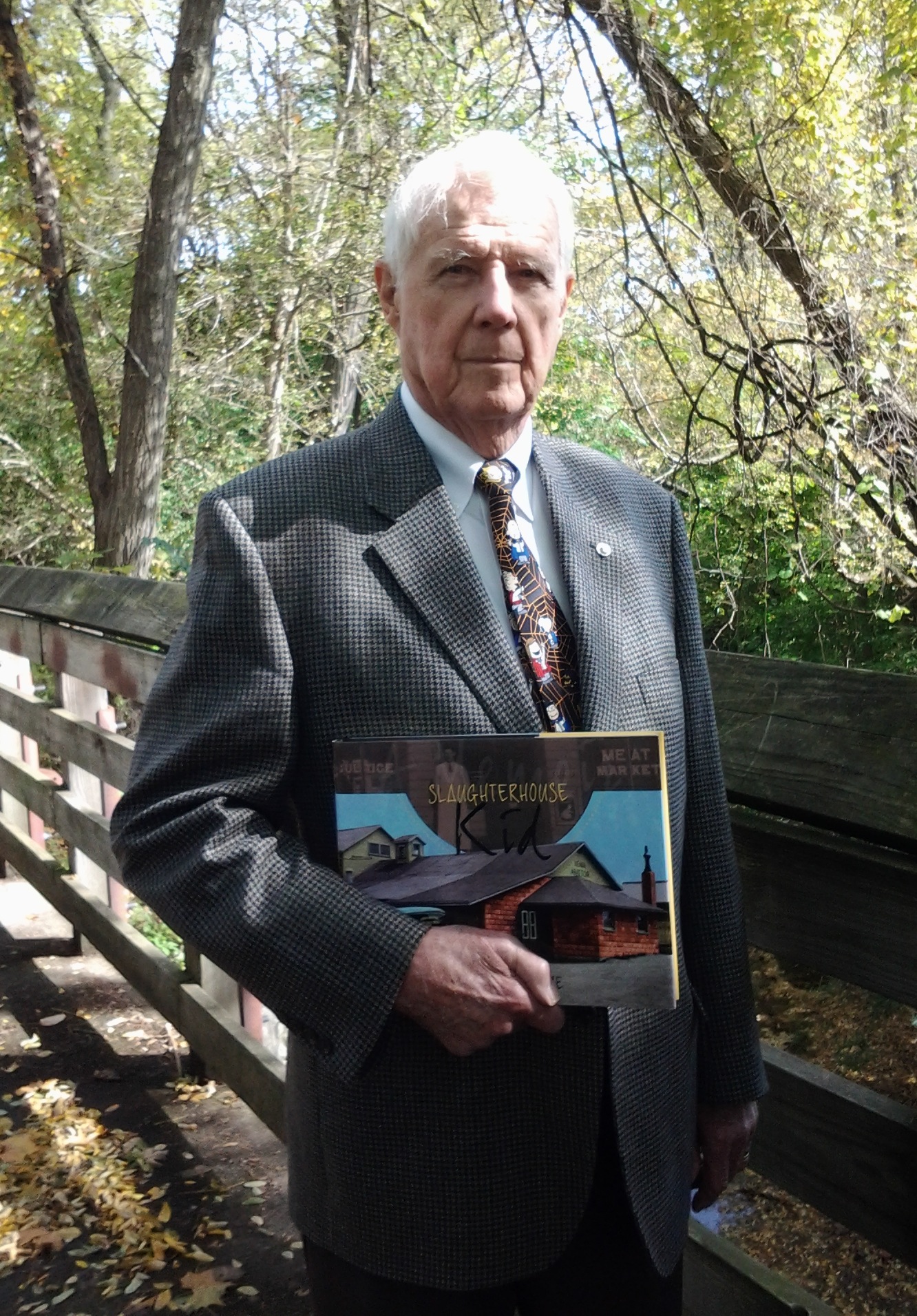 Wendell Cultice with his memoir, Slaughterhouse Kid, a custom book published by Orange Frazer Press