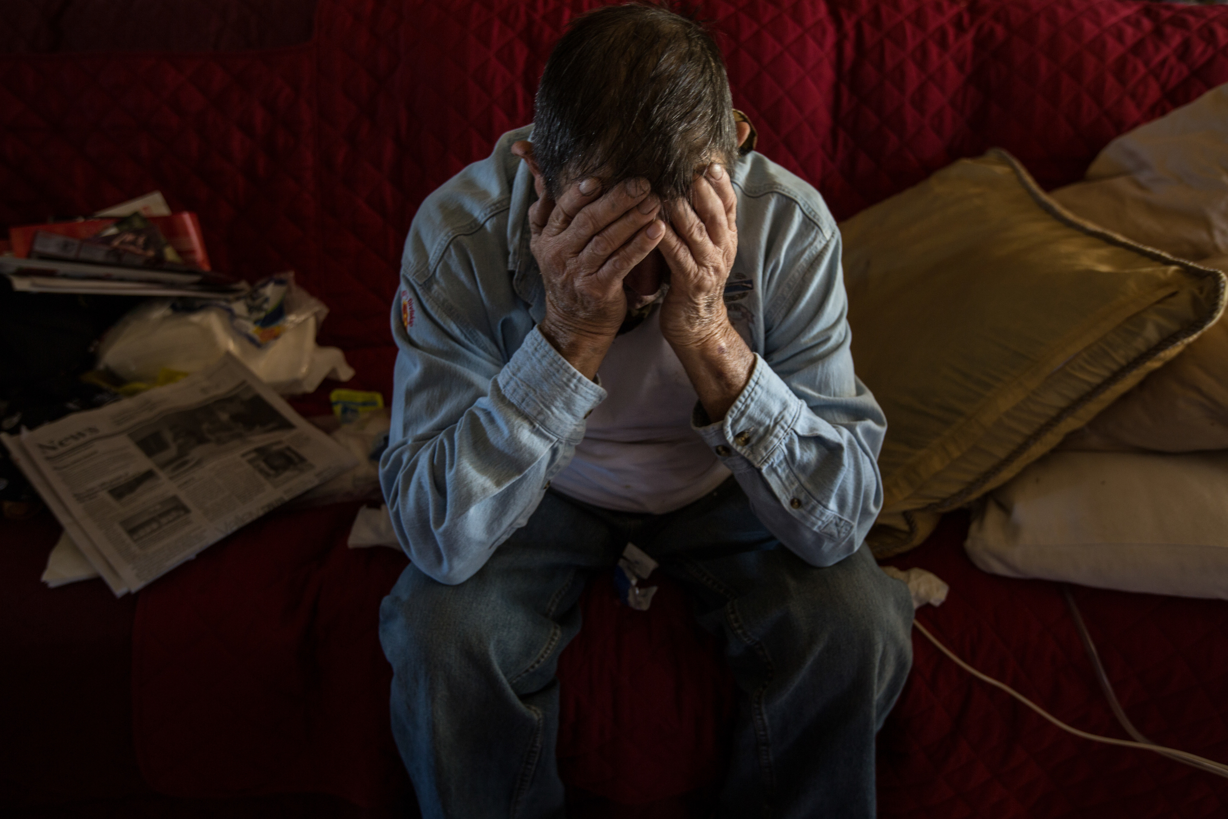   Abe Cardenas rests his head in his hands as he waits for his formula to drip down his feeding tube. It takes hours for him to get a full feeding, which he doesn’t always have time for. In addition to his PTSD, Abe suffered from throat and prostate 
