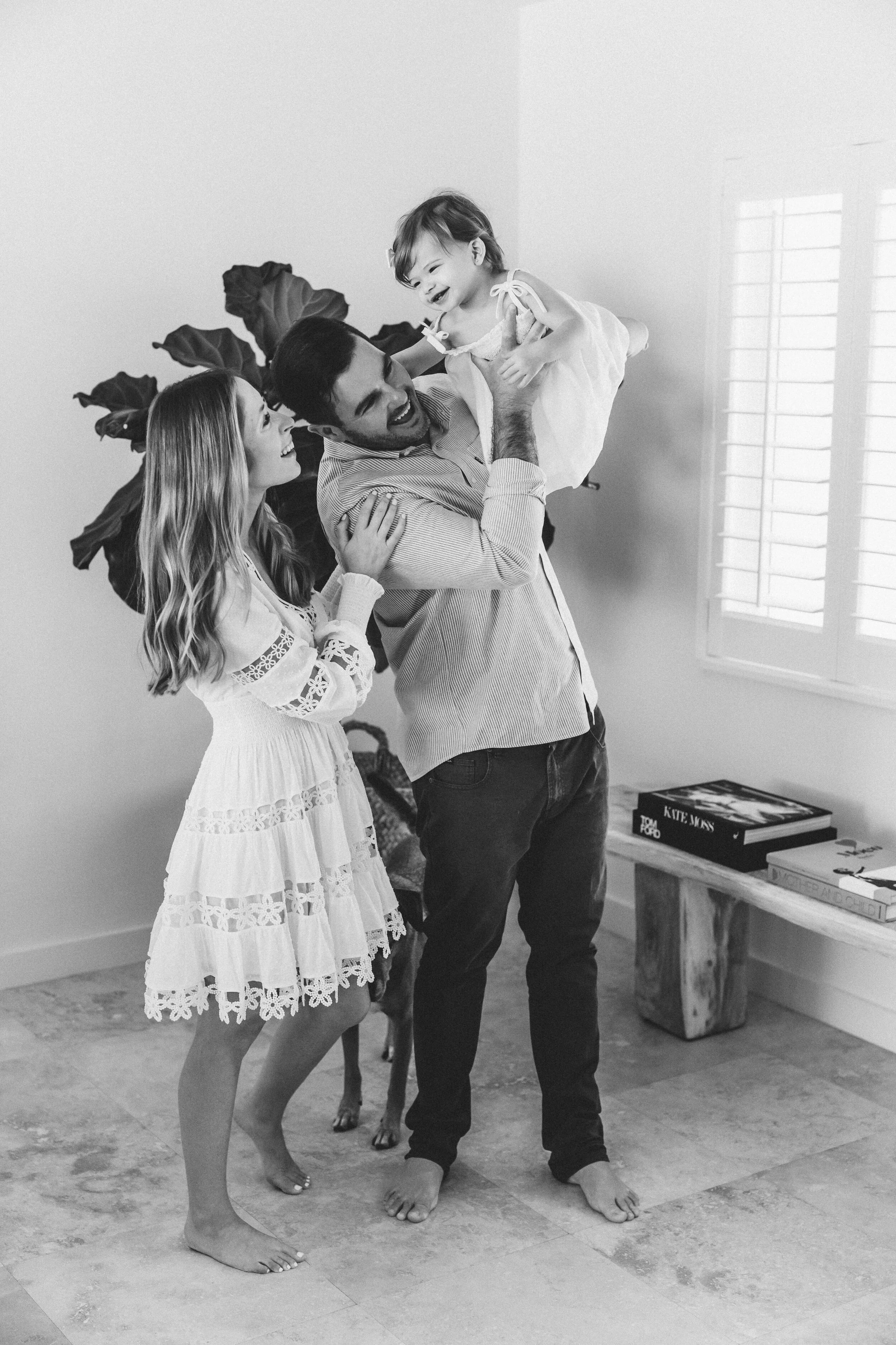 miami-family-photographer-parents-lifting-toddler-joyful-portrait.jpg
