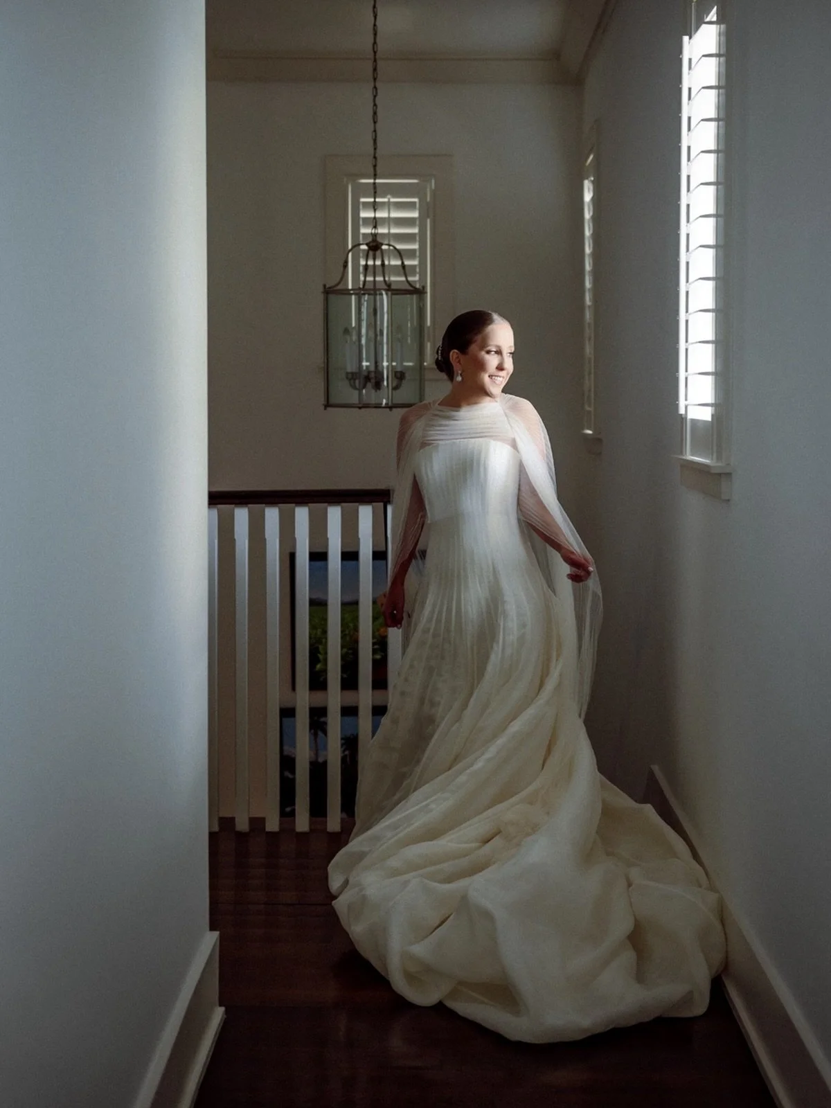 A beautiful portrait of our bride, Cristina at her home, on her wedding day. Moments later, she walked down the steps to show her bridesmaids her incredible wedding look.. needless to say, everyone was floored. She was radiant and truly glowing. It w
