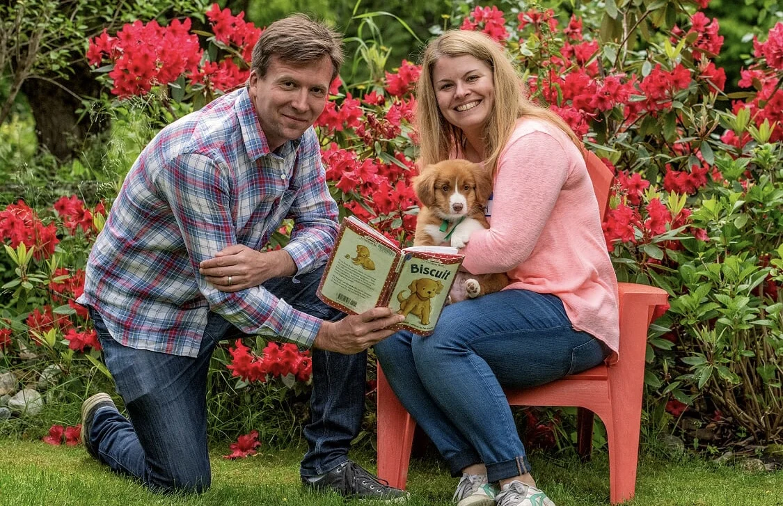 Mike and Lindsay reading to their puppy from the book he was named for. Pic: BC Farm and Family Photography