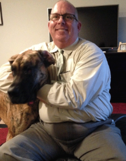 Christopher with his Great Dane, Lily, at their apartment in the Hassalo on Eighth community.