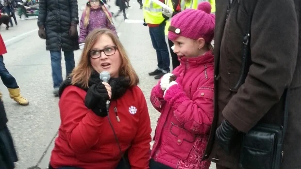 Marcy Markusa, host of the weekday morning radio show on CBC Radio One, is seen here touching base with onlookers at the 2013 Santa Claus Parade. (CBC)