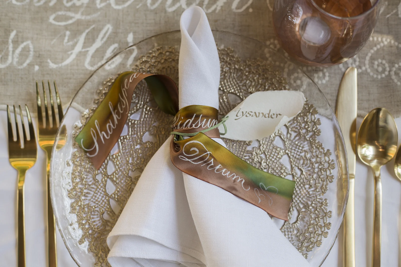 Midsummer Night's Dream inspired wedding shoot // historic Carolingian calligraphy in rose gold on hand-made paper place card scrolls // hand-painted silk ribbons with calligraphy // design and calligraphy by Chavelli www.chavelli.com // photography by Rebecca Jeanson www.rjimagery.com