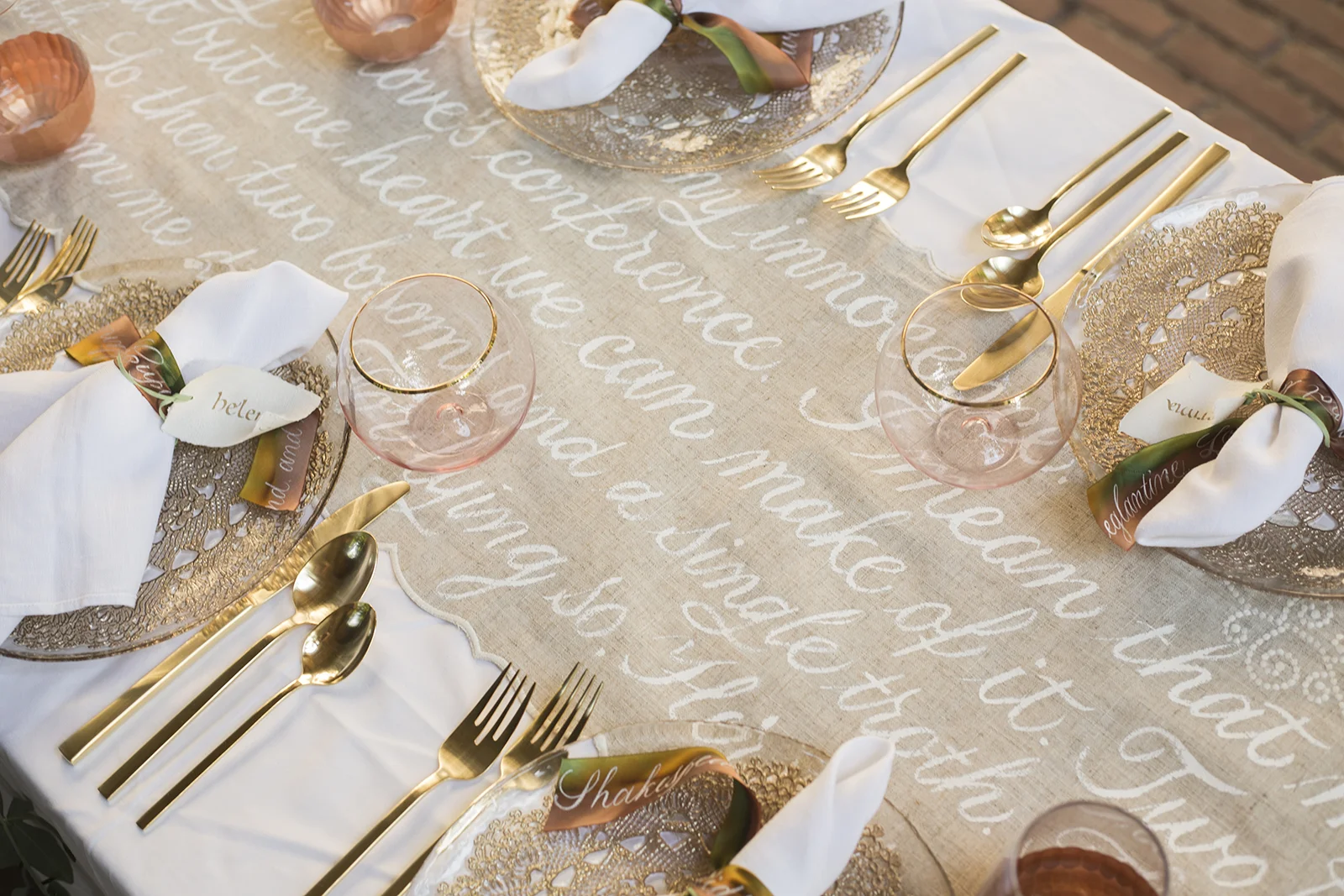 Midsummer Night's Dream inspired wedding shoot // scalloped table runner hand-painted with calligraphy // historic Carolingian calligraphy in rose gold on hand-made paper place card scrolls // hand-painted silk ribbons with calligraphy // paperie and calligraphy by Chavelli www.chavelli.com // photography by Rebecca Jeanson www.rjimagery.com