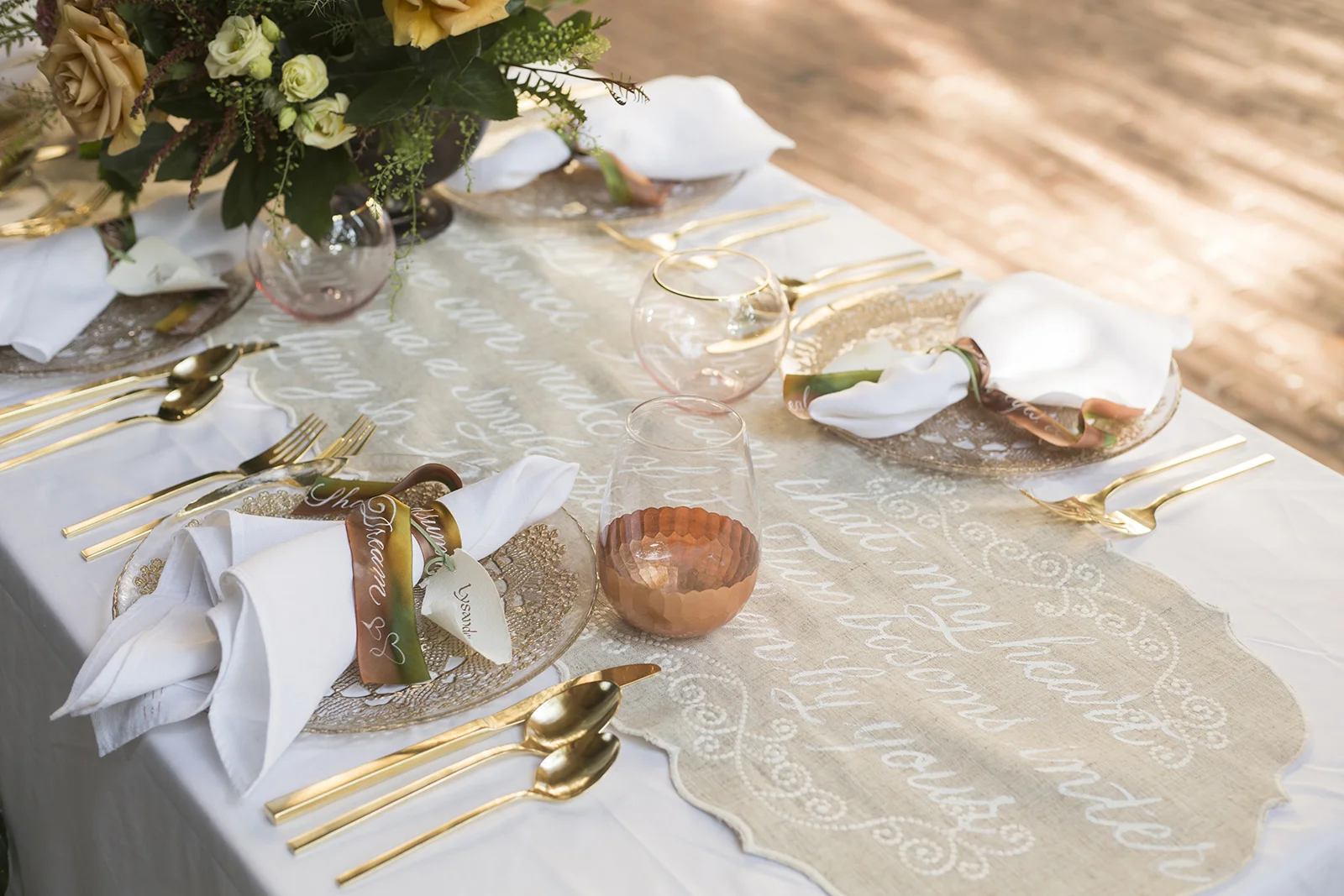 Midsummer Night's Dream inspired wedding shoot // scalloped table runner hand-painted with calligraphy // historic Carolingian calligraphy in rose gold on hand-made paper place card scrolls // hand-painted silk ribbons with calligraphy // paperie and calligraphy by Chavelli www.chavelli.com // photography by Rebecca Jeanson www.rjimagery.com